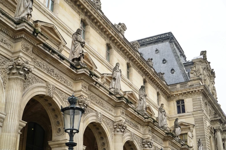 a stone building has a clock on the top of it