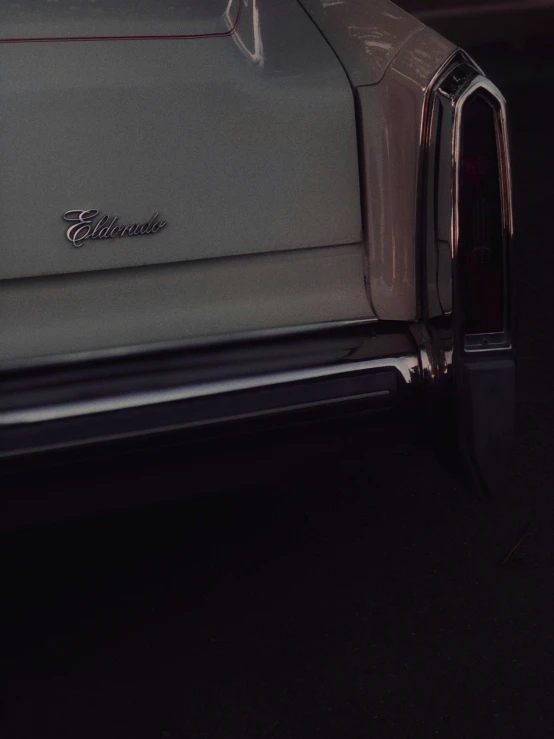 a car parked in the dark, with its hood opened