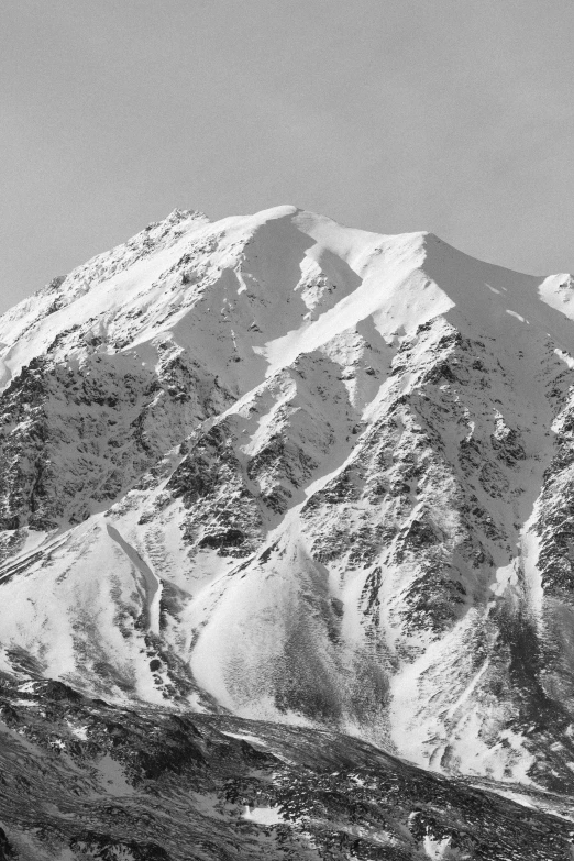 a snow covered mountain range with trees