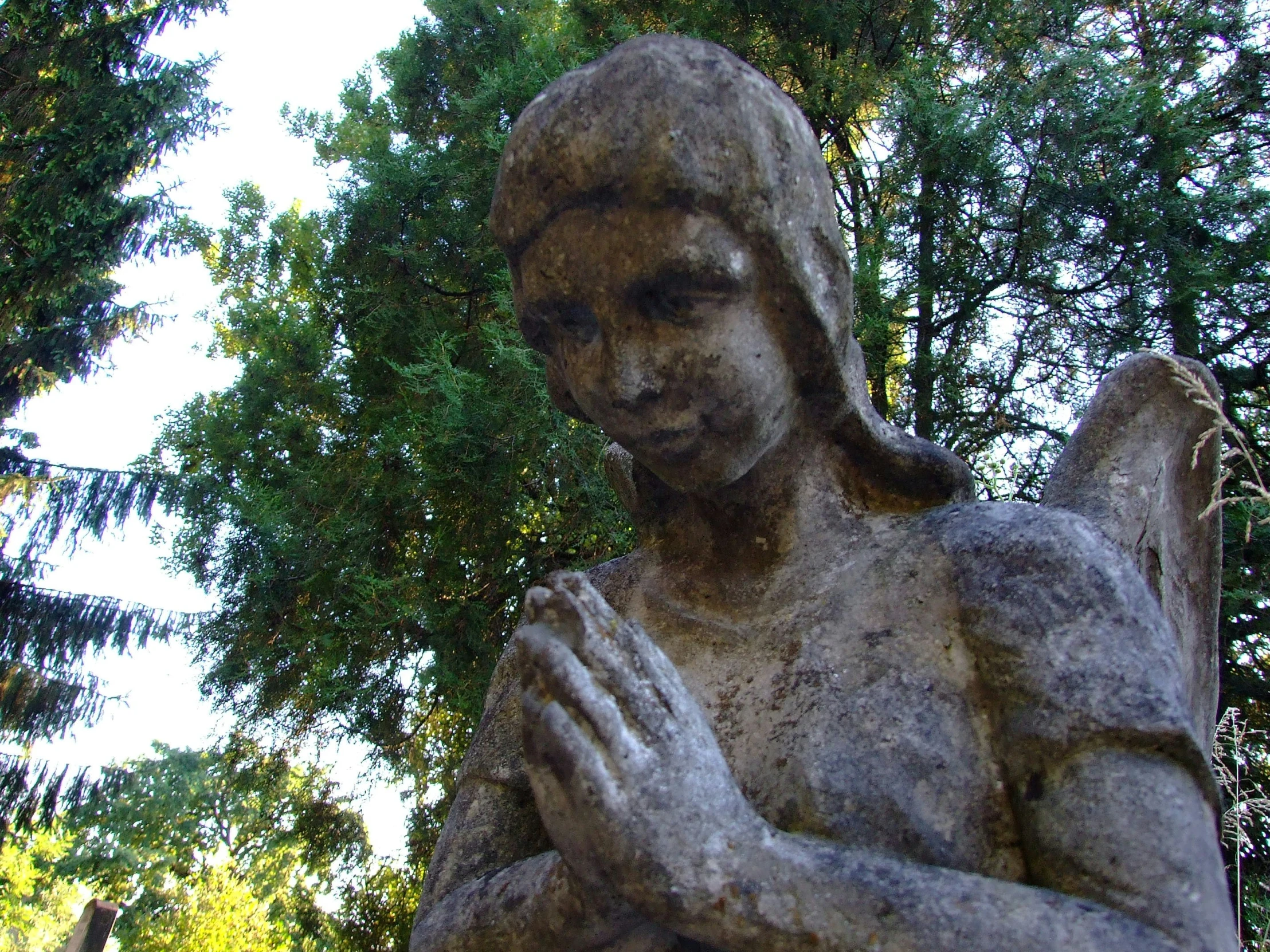 a statue of an angel holding a dove