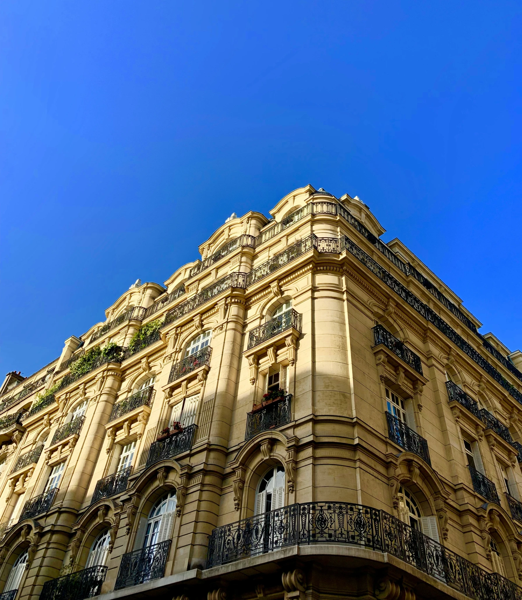 an apartment building on a street corner with many balconies