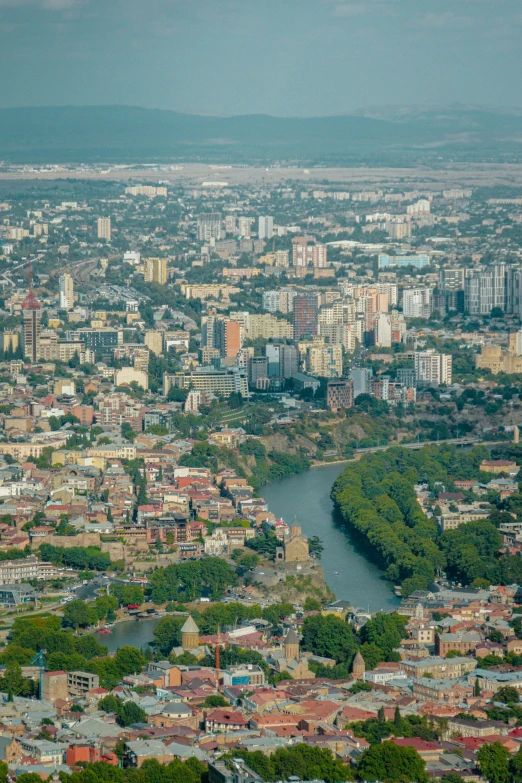 a city is shown with a river and buildings in the middle