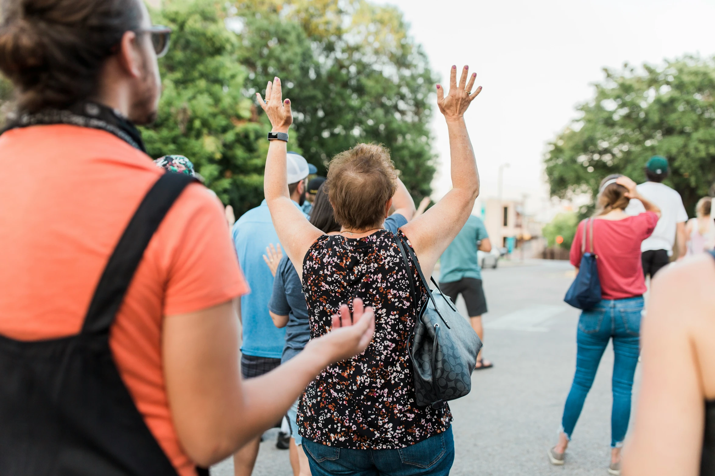 a group of people walking down a street