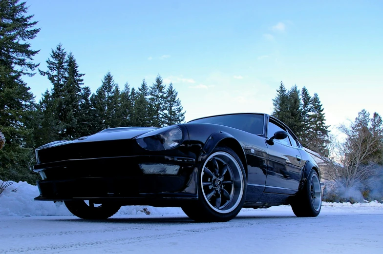 a black sports car with some snow in the front
