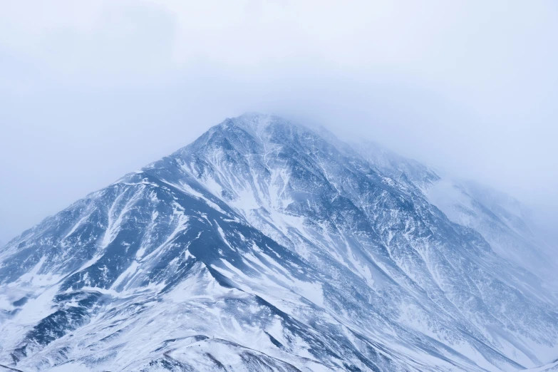 the top of a mountain covered in snow