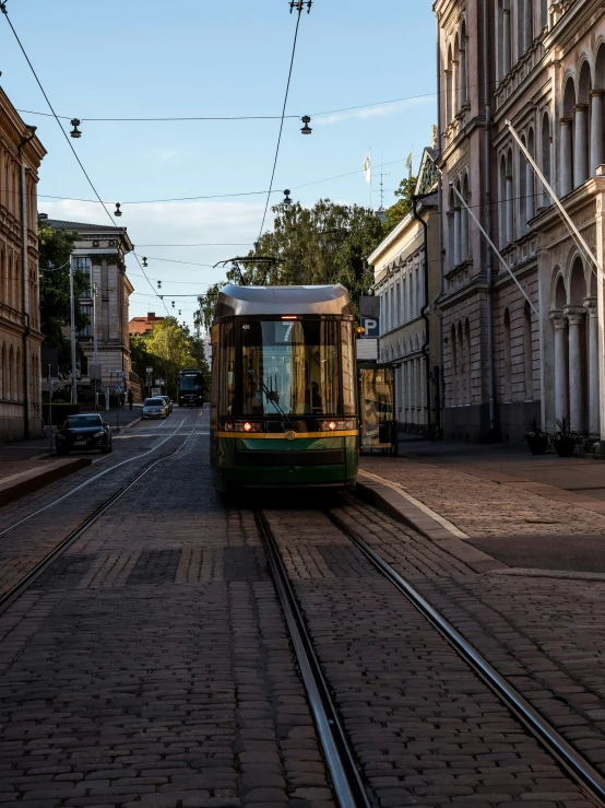 a small train moving along a city street