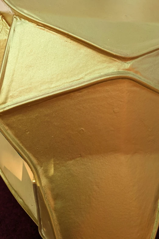 there is gold metallic material on top of a bed