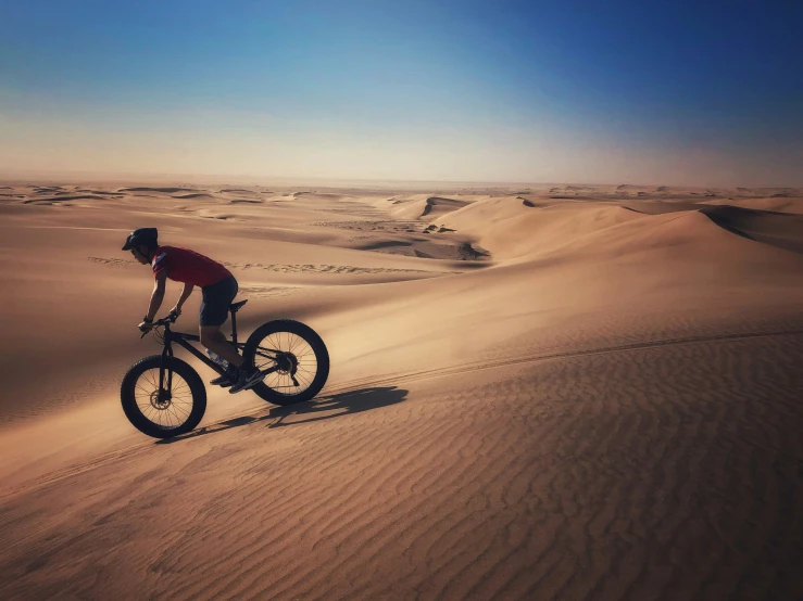 the cyclist is riding his bike in the desert