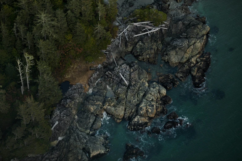 aerial view of rock formations and water with trees