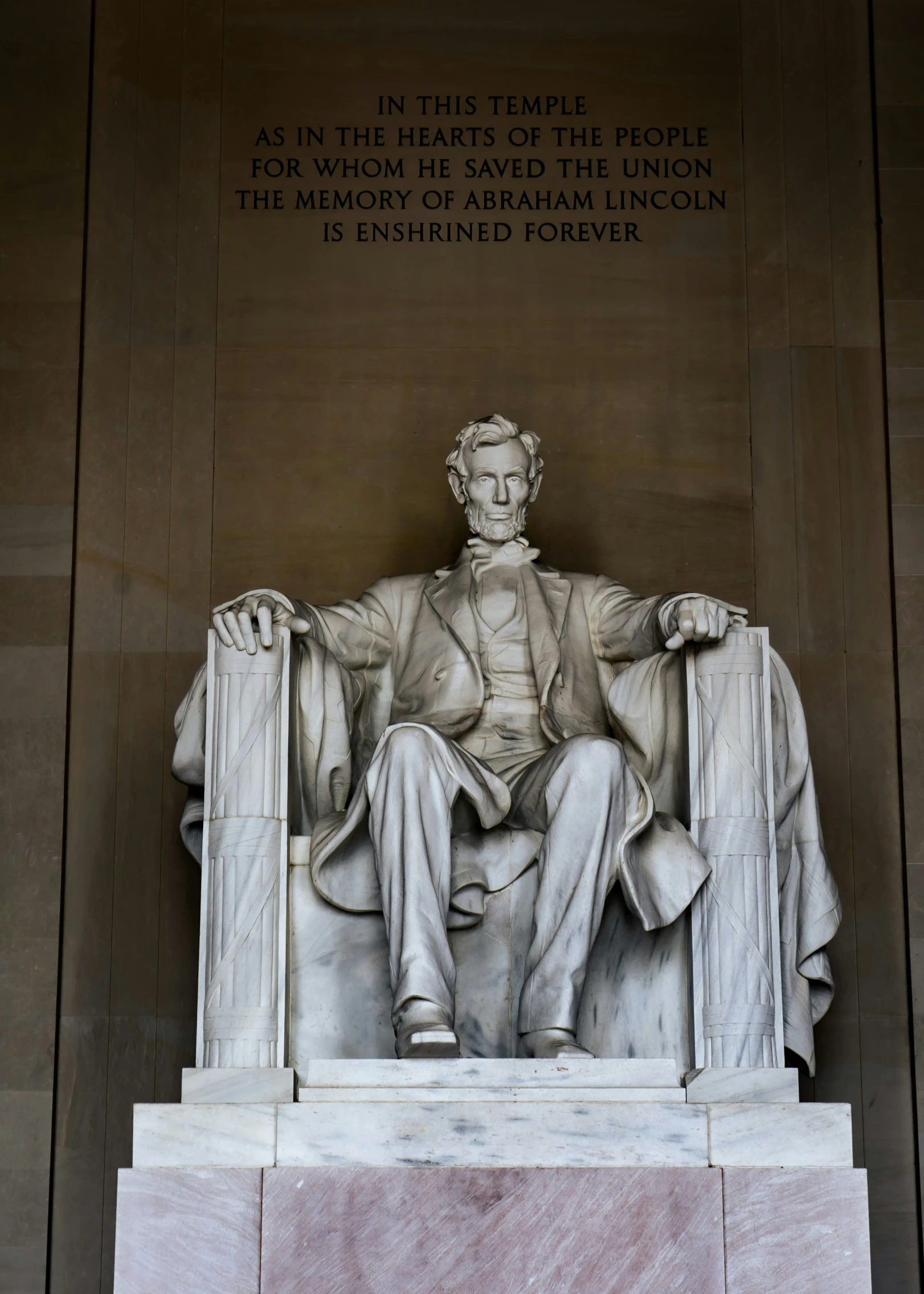 a statue of aham lincoln with a plaque written in human languages