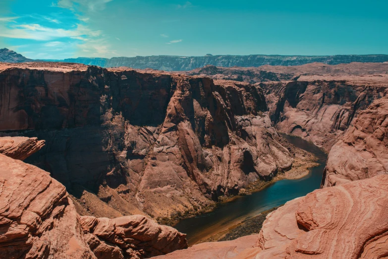 a very large rocky mountain by a river