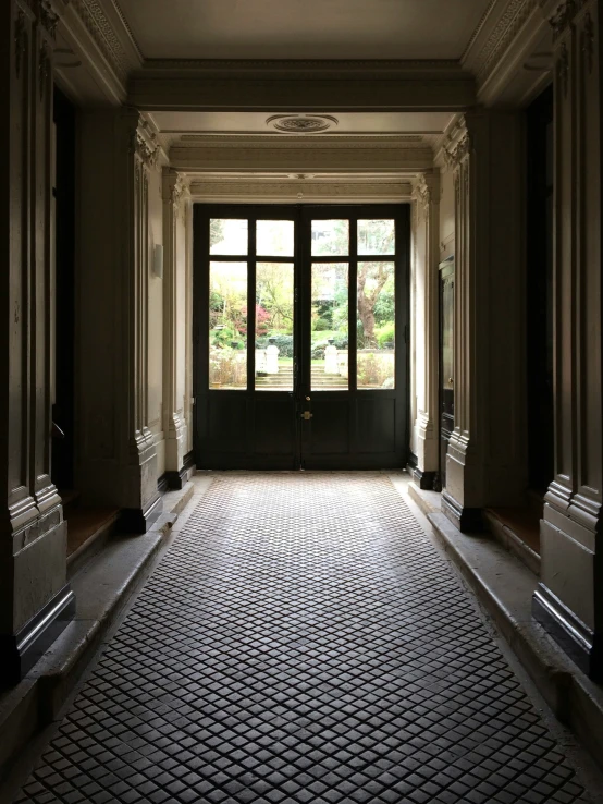 a long, empty room with a bench and two windows