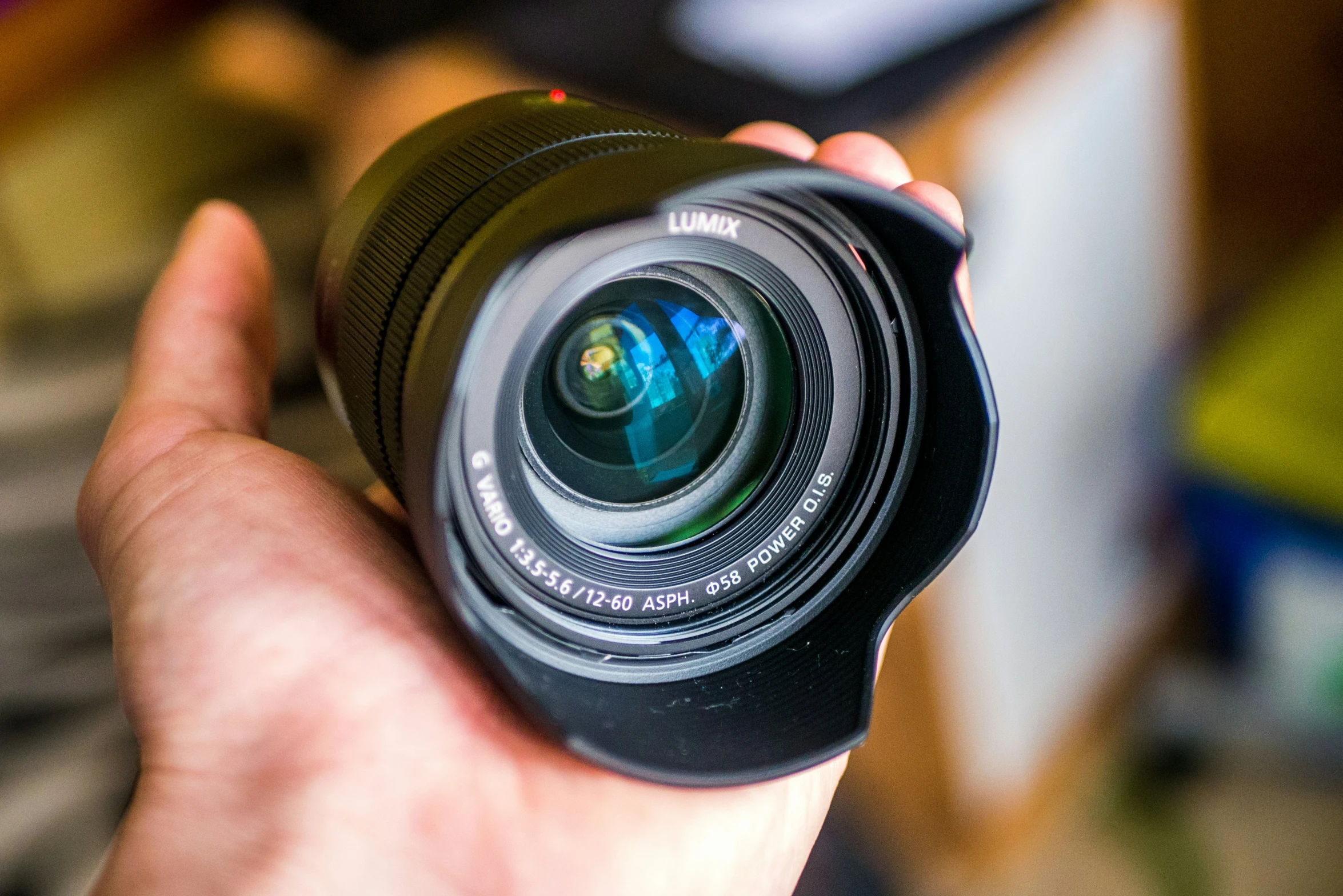 a person holding a lens in their hand