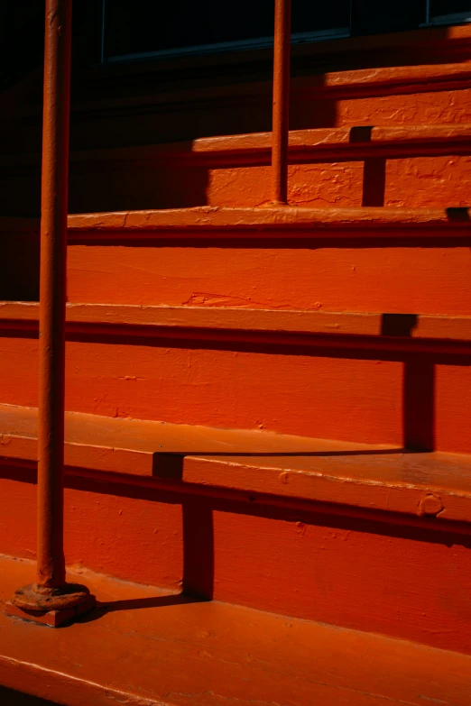 a number of old orange steps with metal hand rails