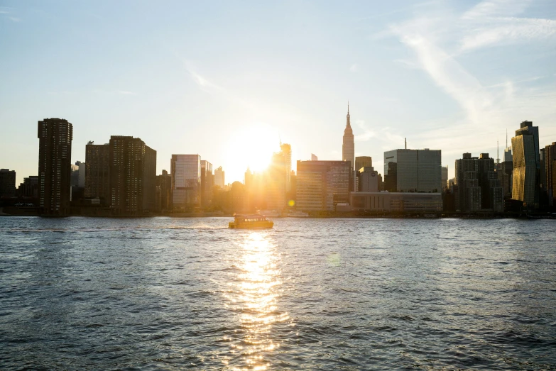 a boat is traveling down a river near the city skyline