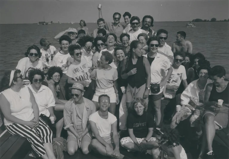 a group of people standing on top of a boat