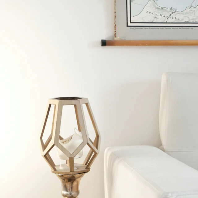 a white living room with a white sofa and wall decor