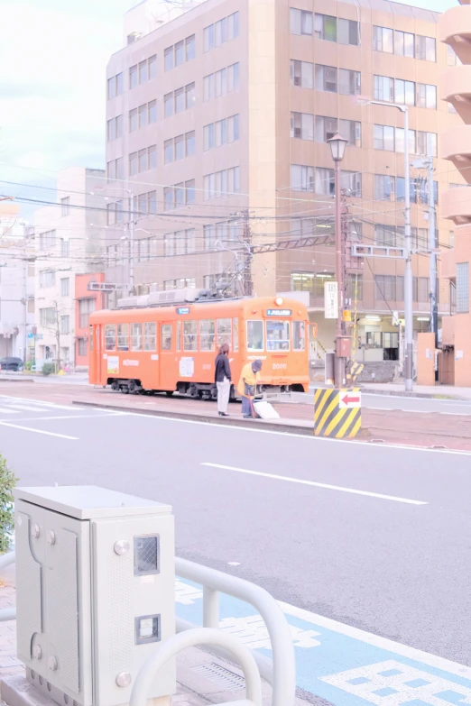 a couple of trains on a street in the city