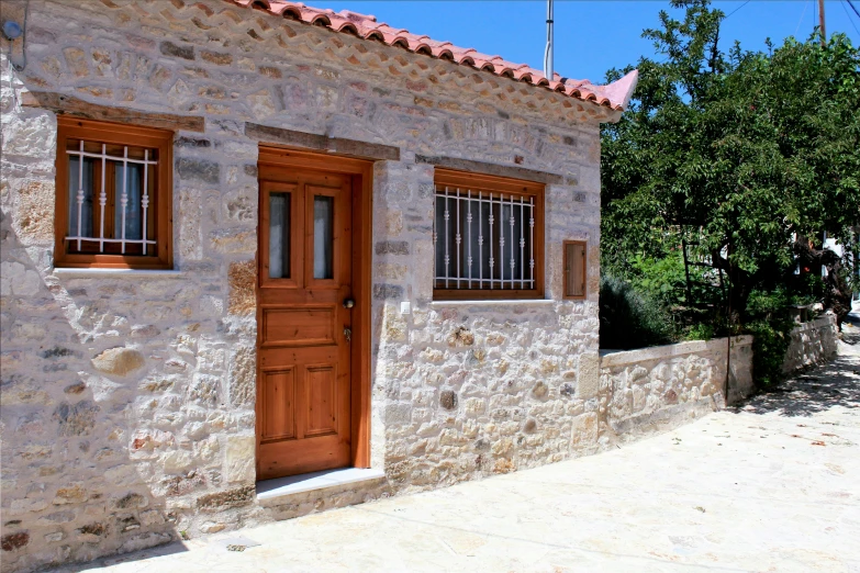 an old stone house with a wooden door and window