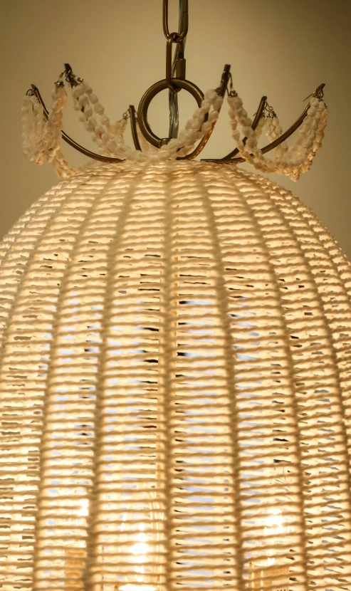 there is a wicker light fixture hanging from the ceiling