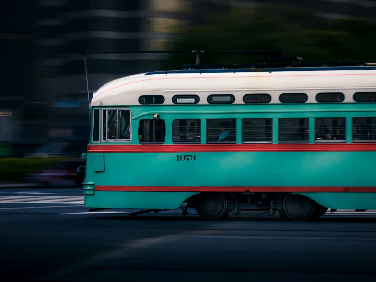 a green trolley with red trim and white top