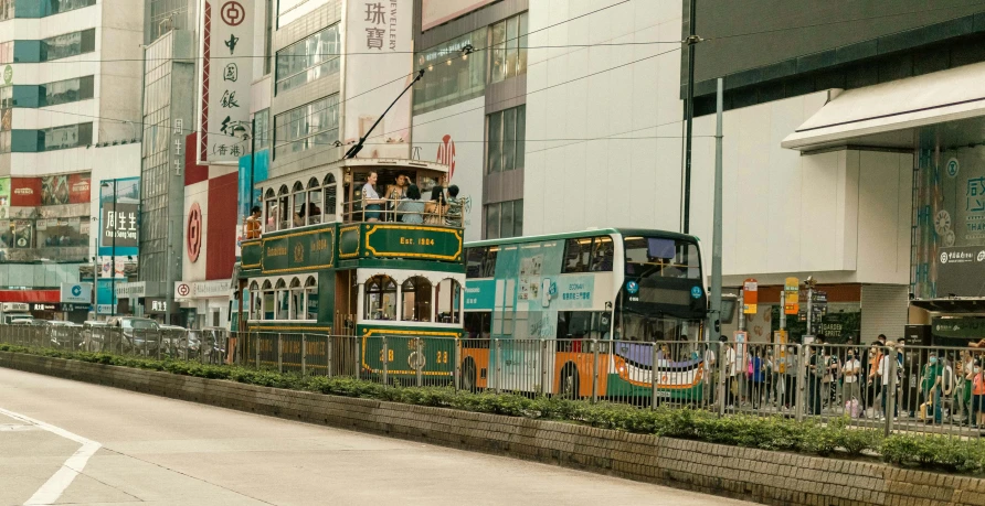 an old style bus on the street with people in front