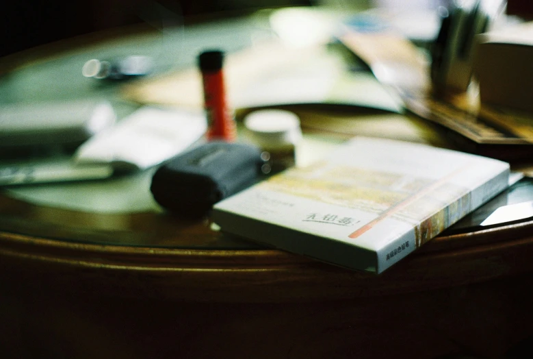 several books are sitting on a wooden table