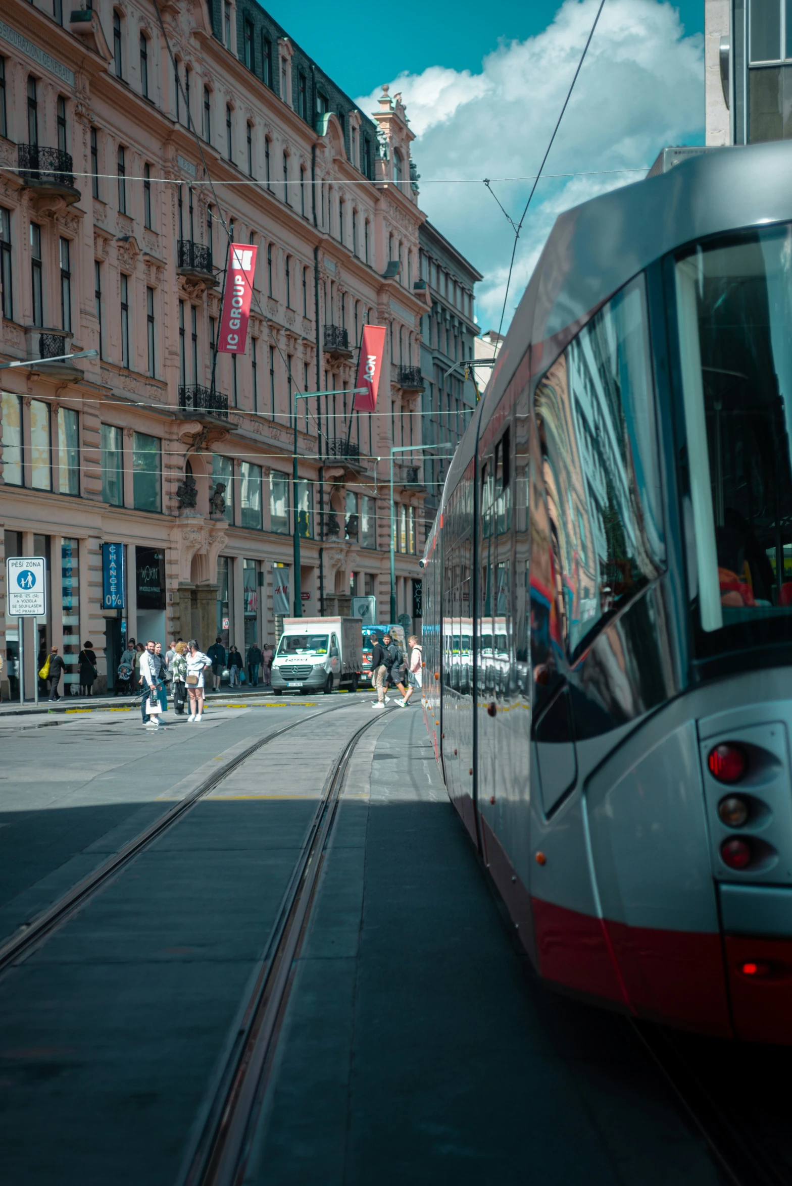 a red and grey metro train on city street