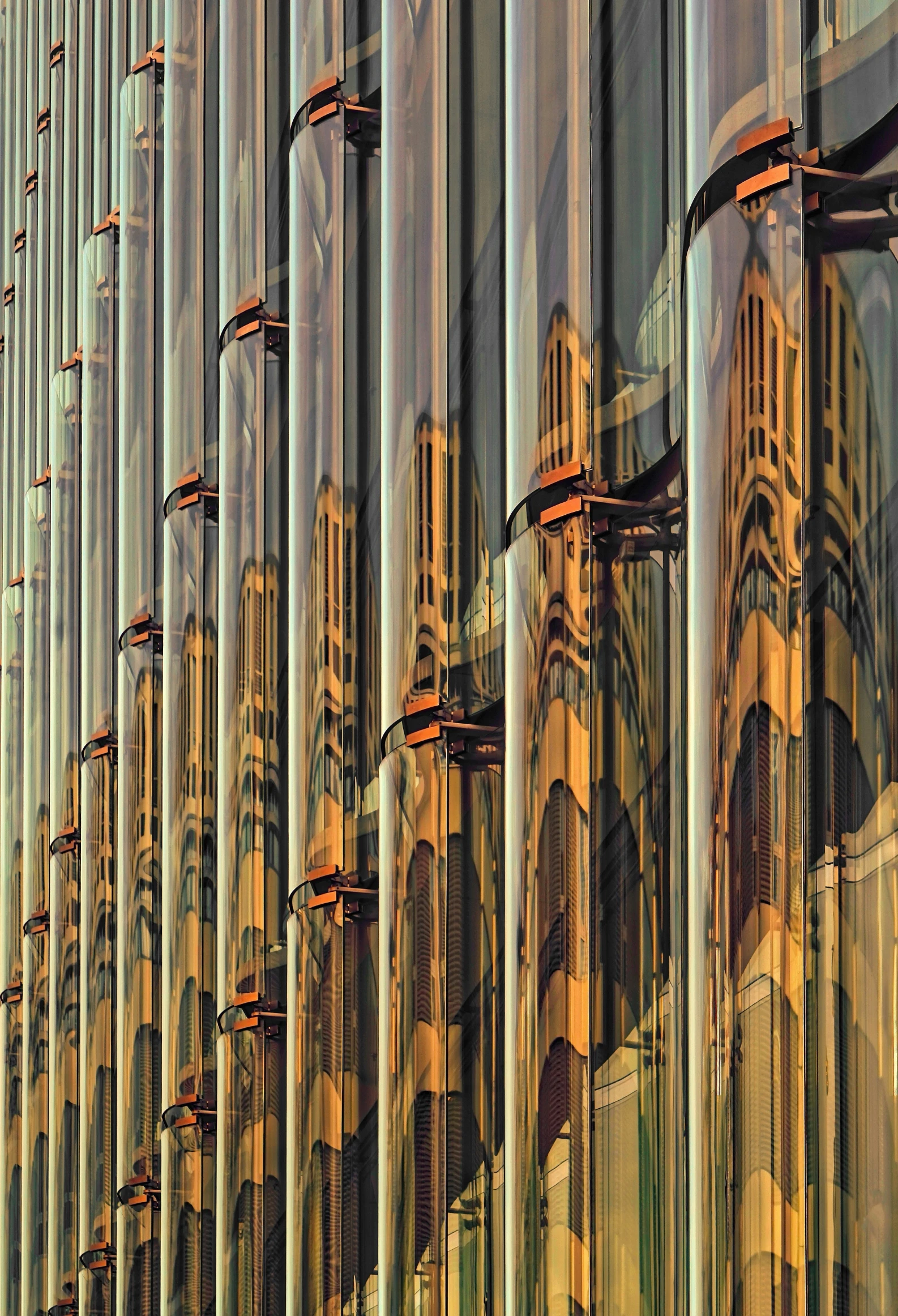 the architectural of many large buildings are reflected in a glass wall