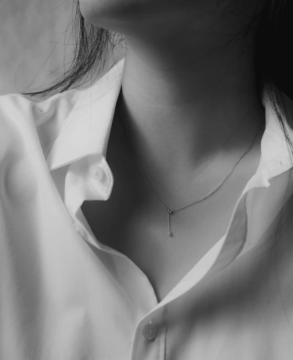 black and white po of a woman with long hair wearing a shirt