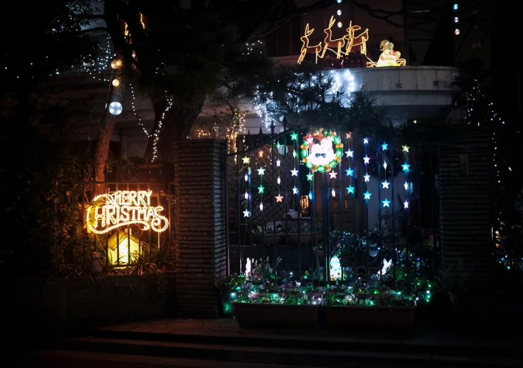 an outdoor display of christmas lights and a gate