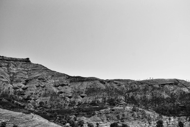 a black and white po of an airplane flying over a mountain