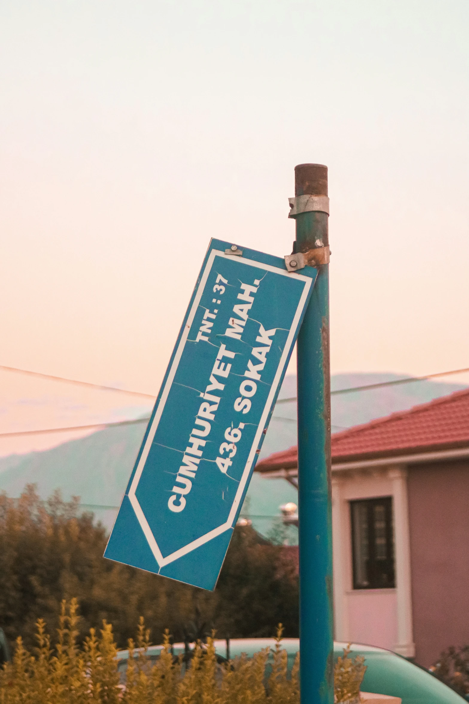 a blue street sign that is posted on the pole