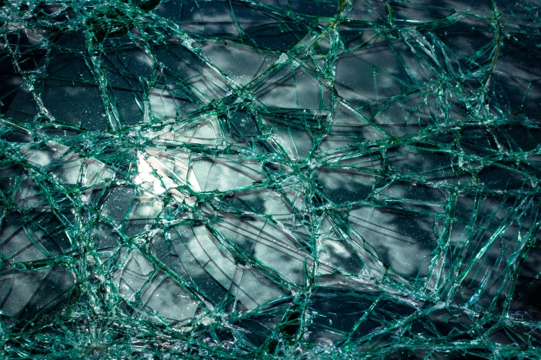 close up of a broken glass with green tints