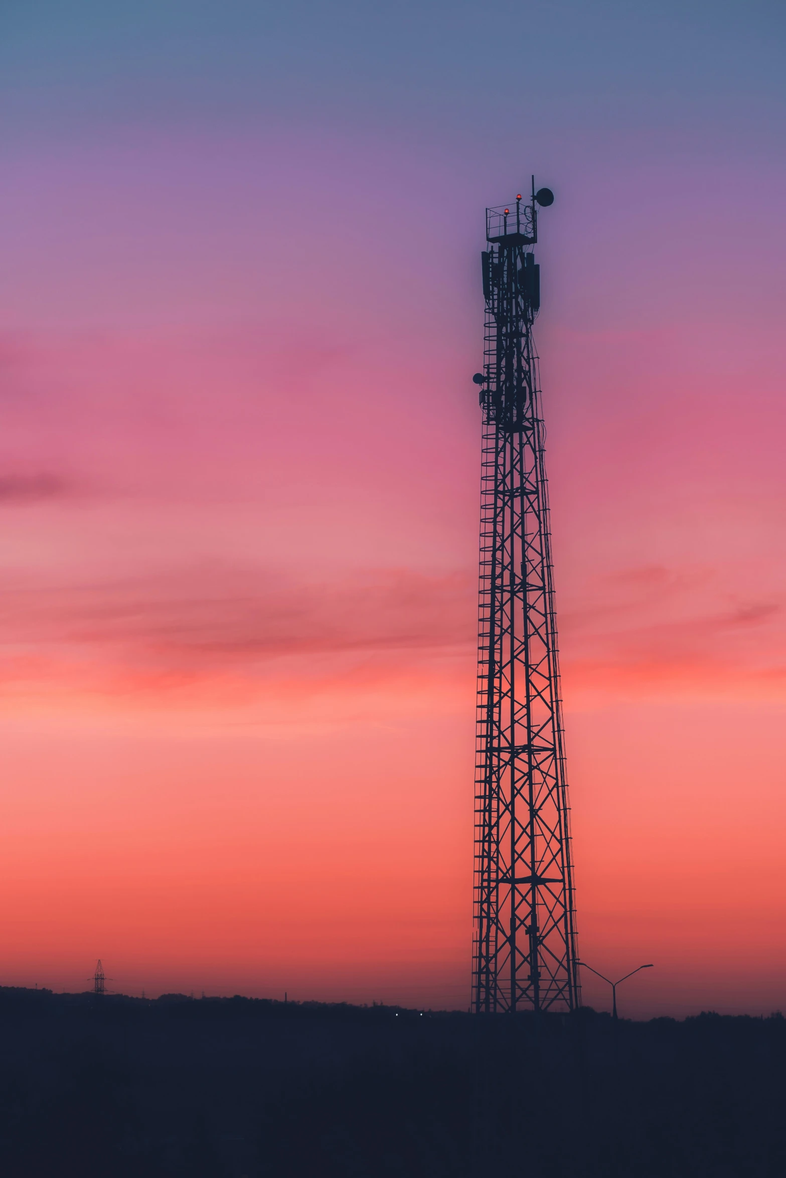 a tall tower with a red sky in the background