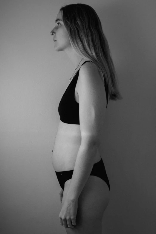 a black and white image of a pregnant woman