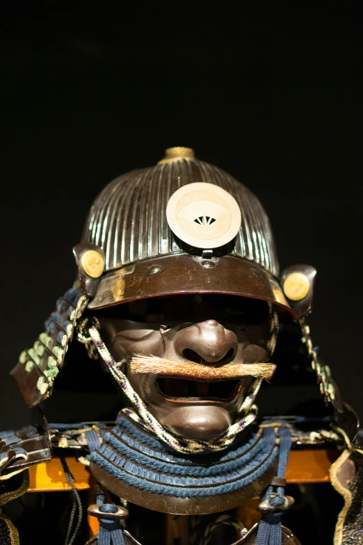 a close up view of a decorative figurine with an unusual headpiece