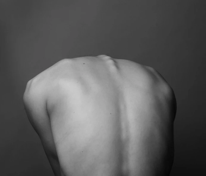 a black and white po of a man's back