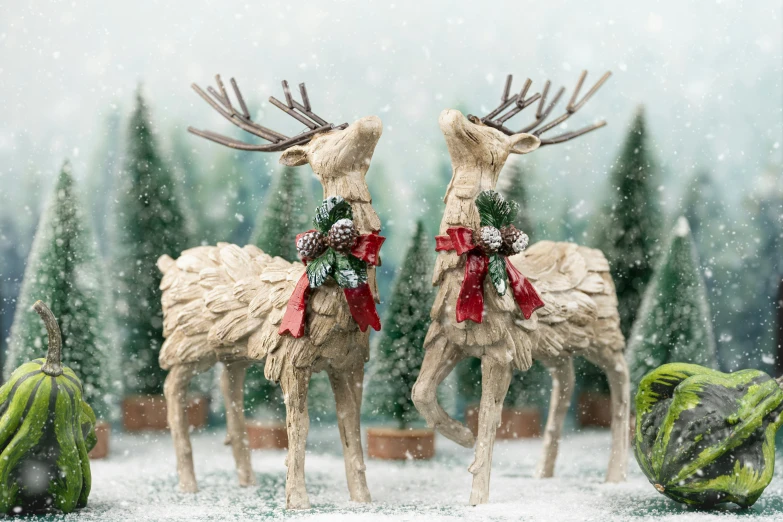 the two santas are made of reindeer statues