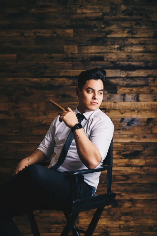 the man poses while wearing a tie with a cigar