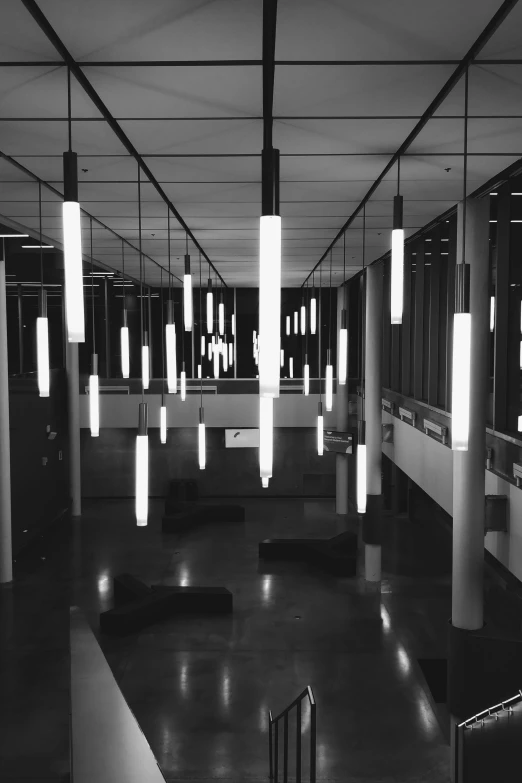 several lights hang from the ceiling in the dark room