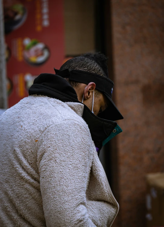 a man wearing ear pieces and a scarf