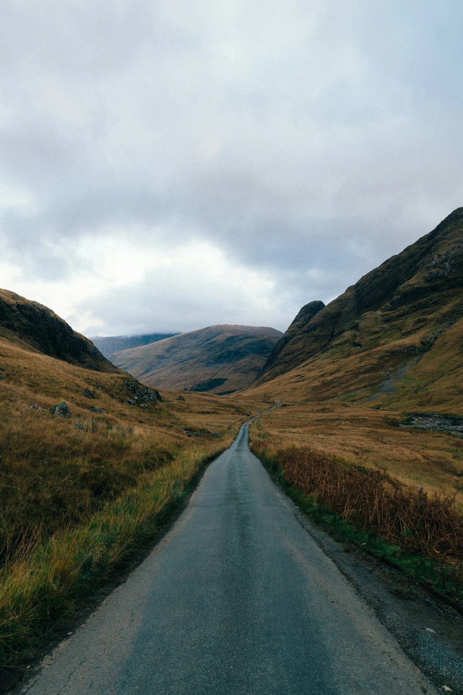 a curve road in the middle of mountains