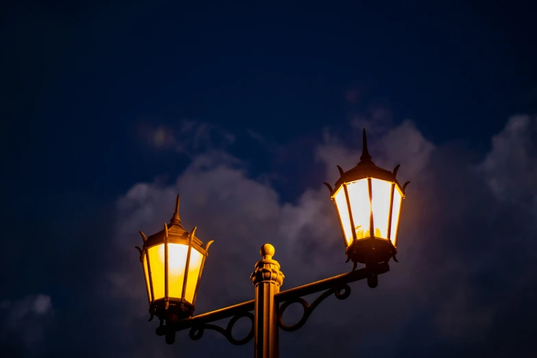 a light post sitting under some cloudy skies