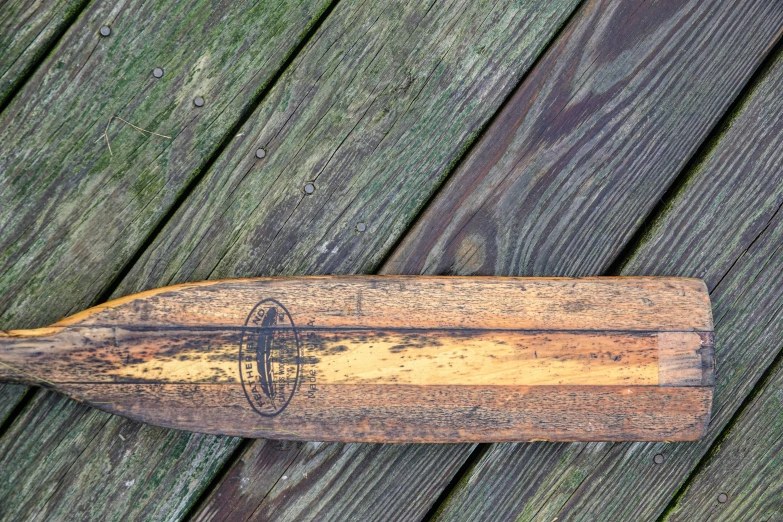 an old baseball bat is displayed on a deck