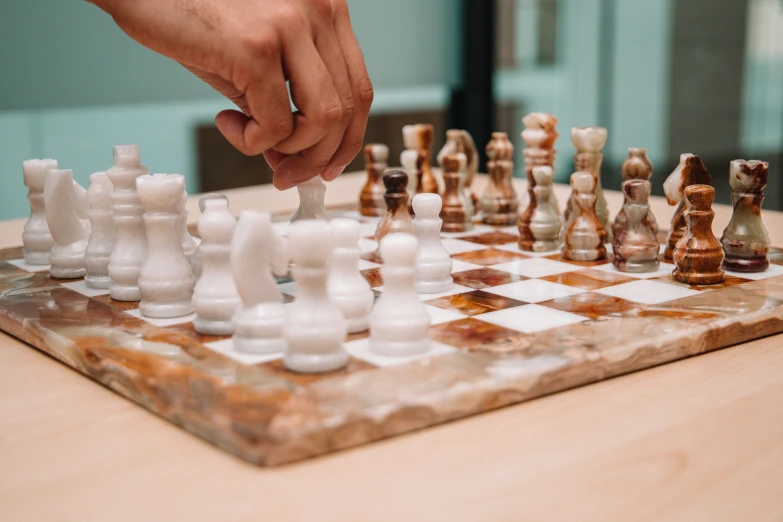 a person playing with a chess board