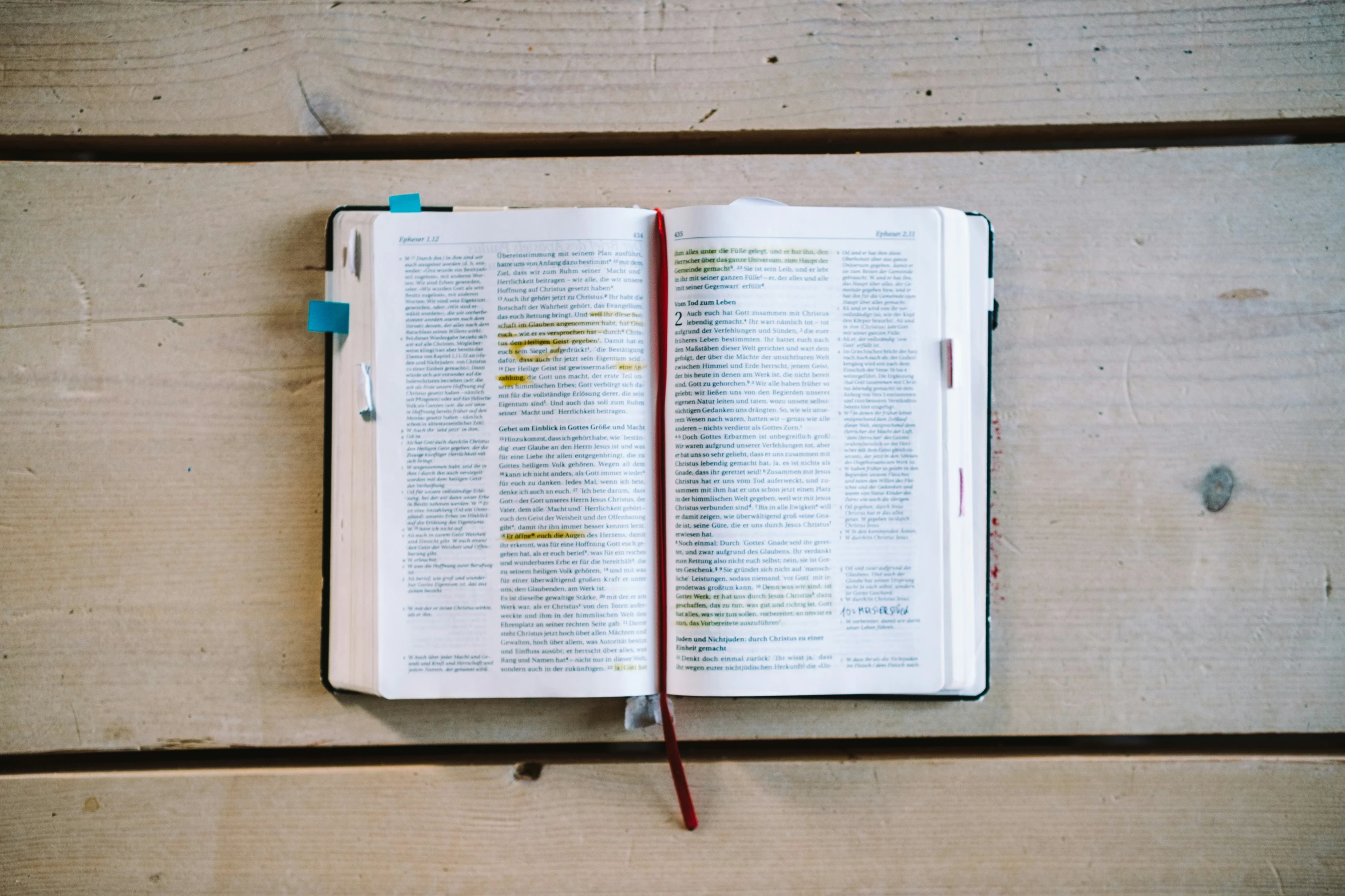 an open book sits on a wooden table