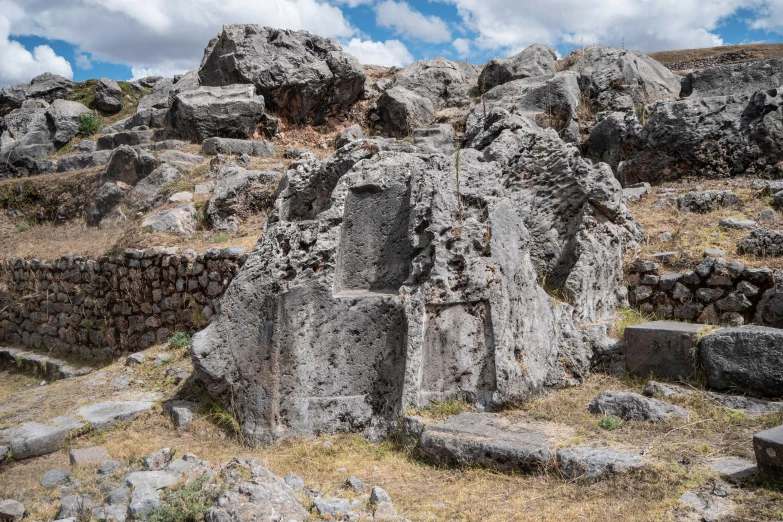 there are two large sculptures on this rocky hill