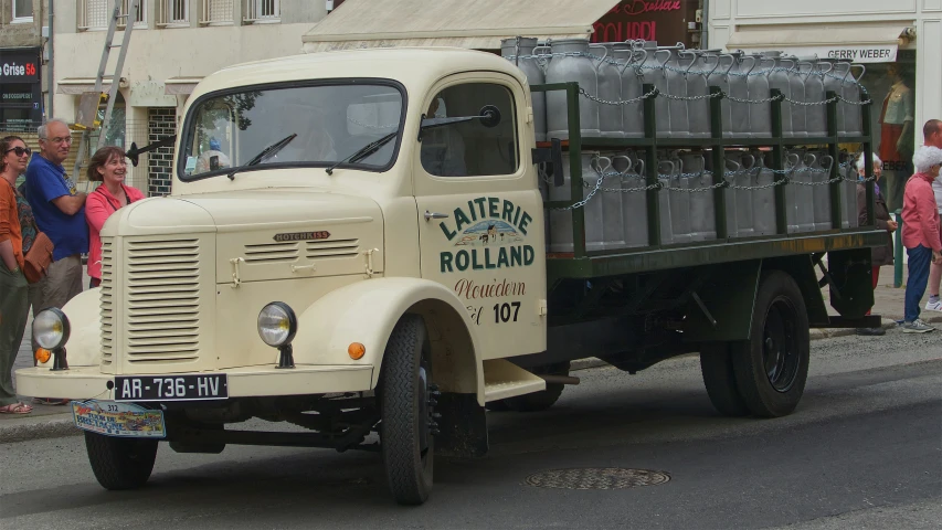 an old truck with beer keg on the back of it