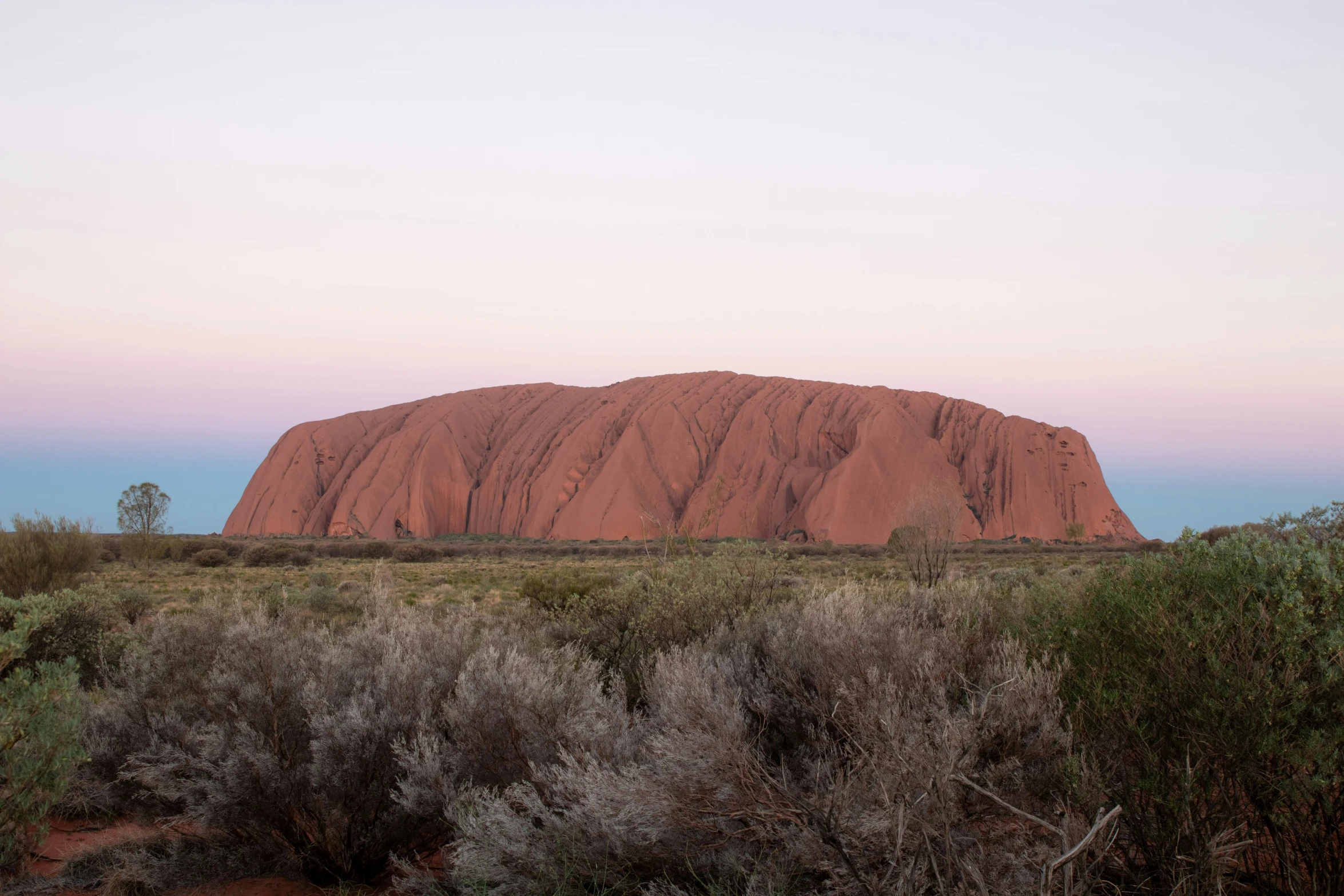 an image of ayella rock from across the river